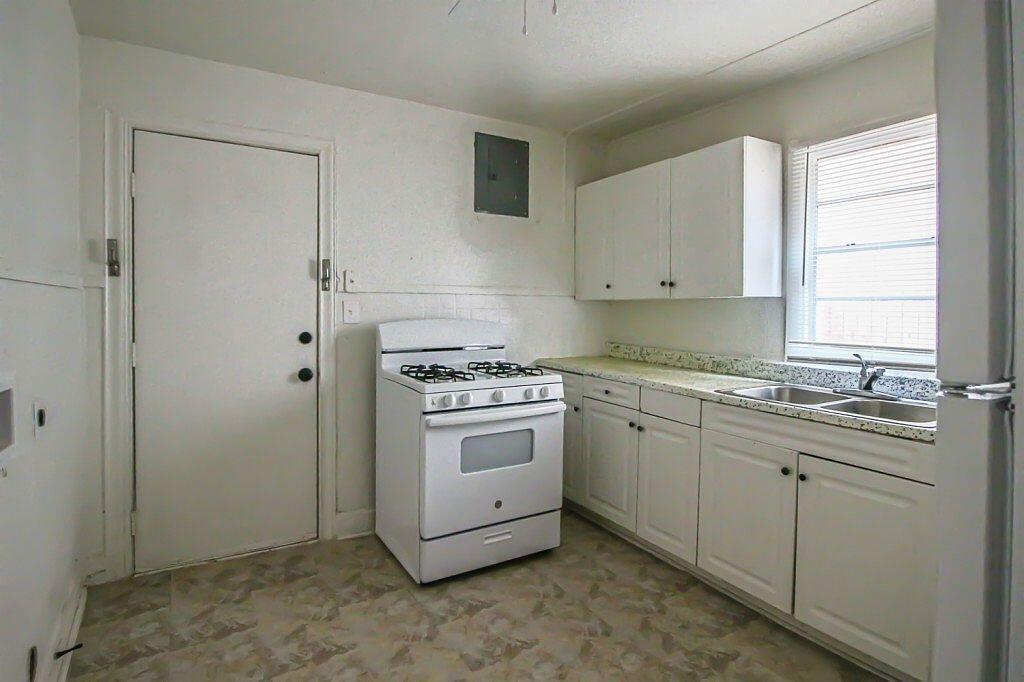 1805 Avenue R Lubbock, TX 79401 - Photo 17 of 18 a kitchen with sink cabinets and window