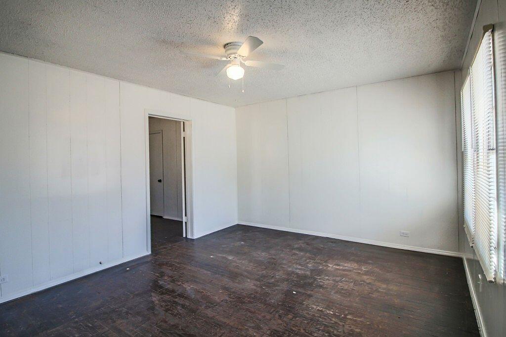 1805 Avenue R Lubbock, TX 79401 - Photo 2 of 18 an empty room with a window and a ceiling fan