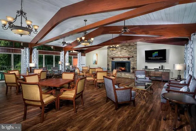 a living room with furniture a fireplace and a dining table