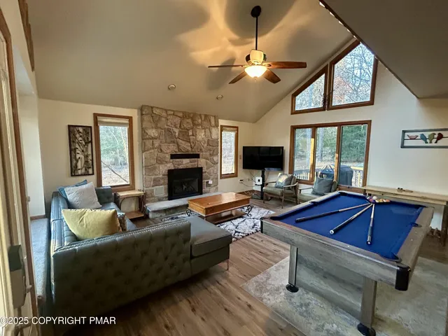 a living room with furniture fireplace and flat screen tv
