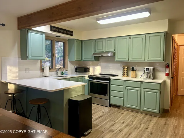 a kitchen with sink a microwave and cabinets