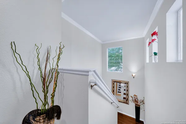a view of a hallway with paintings on the wall