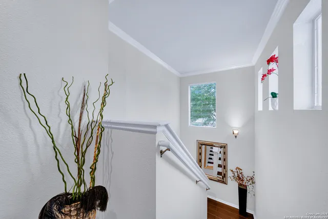a view of a hallway with paintings on the wall