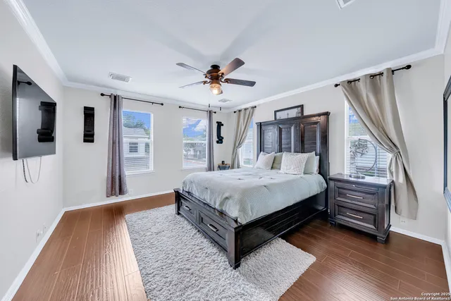 a bed sitting in a spacious bedroom next to a window