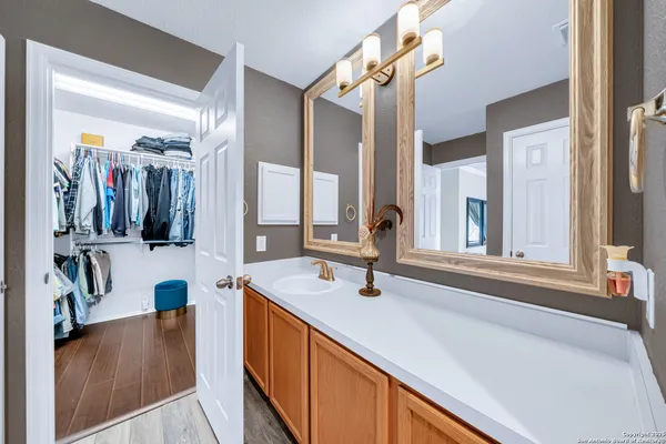 a bathroom with a tub sink and mirror