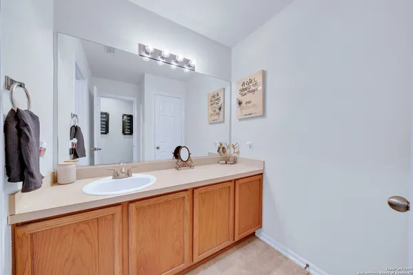 a bathroom with a sink a vanity and a mirror