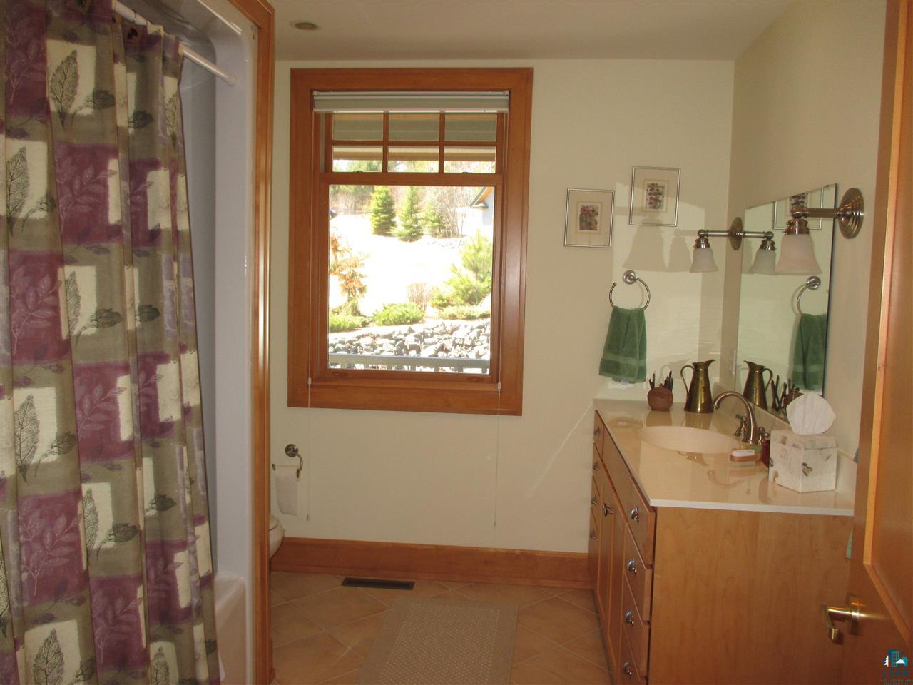 37433 Apostle Bay Road Bayfield, WI 54814 - Photo 24 of 49 Adjacent to main floor bedroom, with hall & pocket door for a private suite.