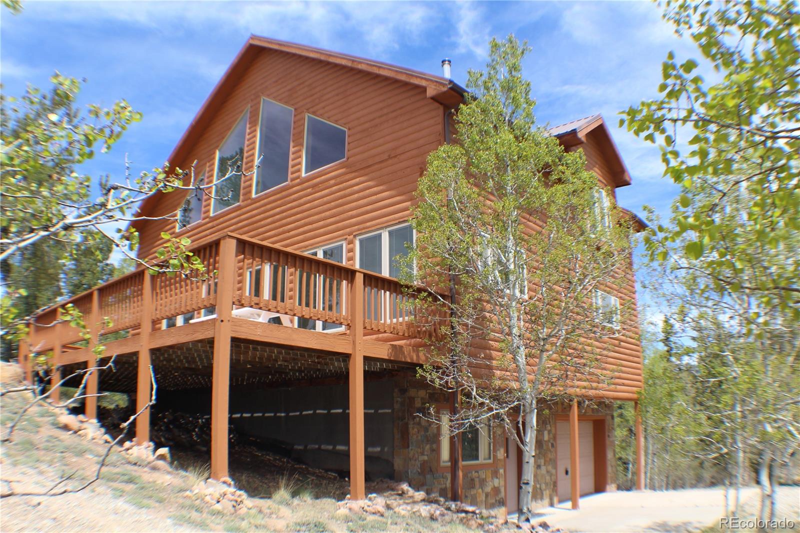 8221 Remington Road Como, CO 80432 - Photo 1 of 49 a house with a tree in front of it