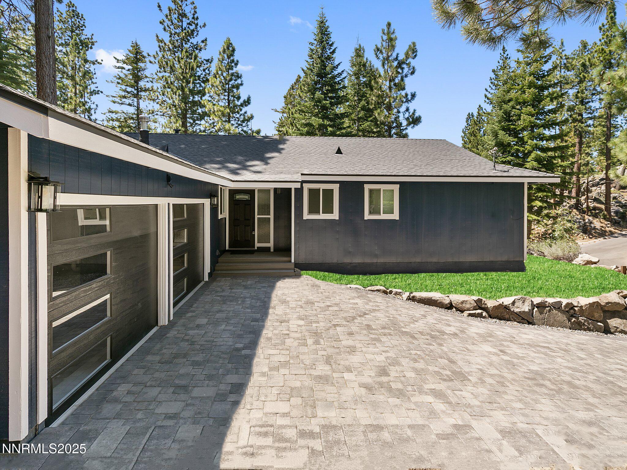 421 Edgewood Drive Stateline, NV 89449 - Photo 16 of 29 a front view of a house with a yard and garage