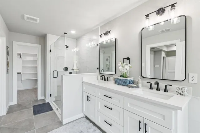 a bathroom with a double vanity sink mirror and double