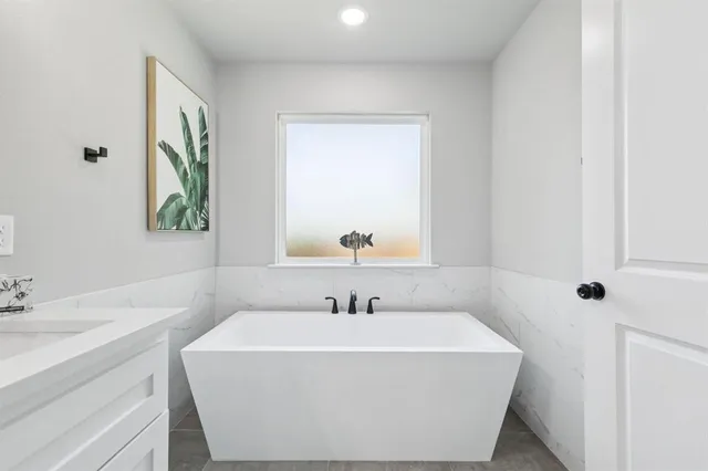 a white bath tub sitting next to a white sink