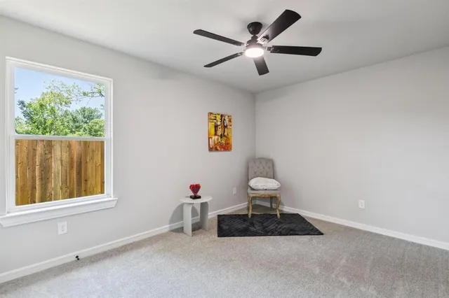 a very nice looking room with a window and a ceiling fan
