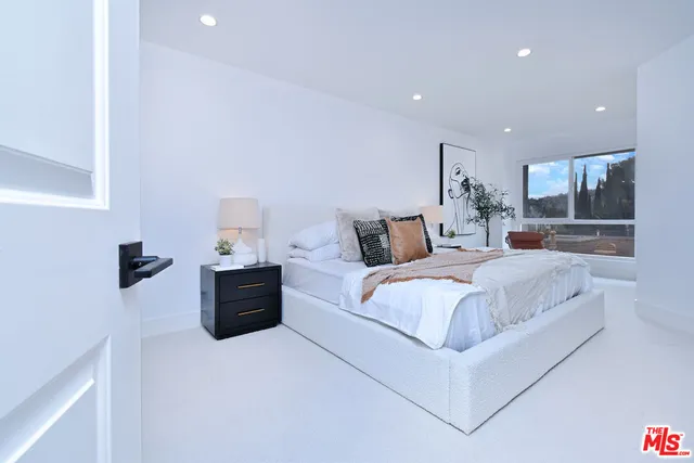 a bathroom with white cabinets sink and mirror