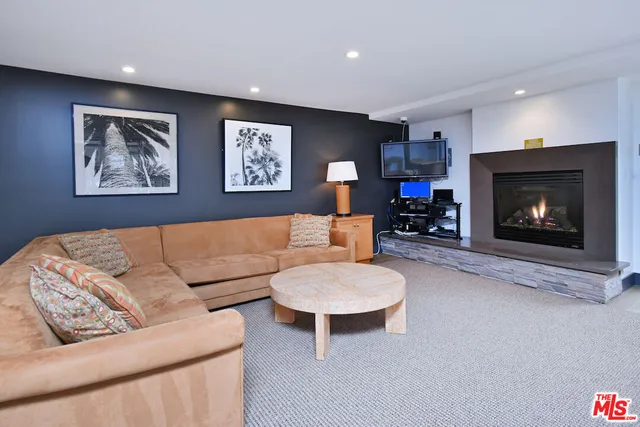a view of a swimming pool with chairs and a table