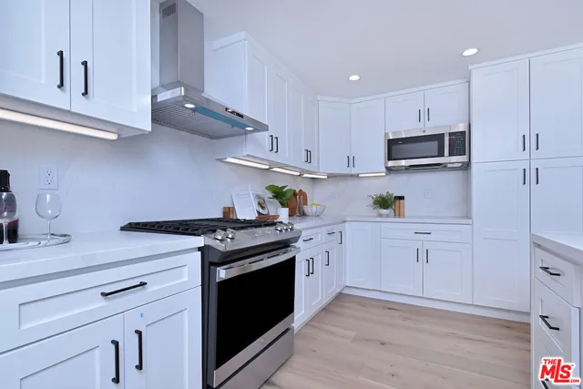a large white bed in a white room