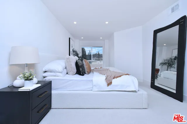 a bedroom with bed and window