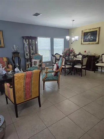 a view of a dining room with furniture and a chandelier