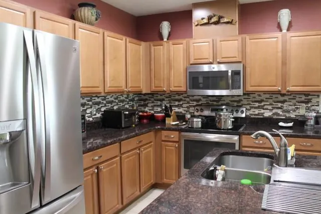 a kitchen with sink a window and cabinets