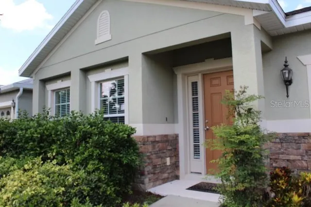 a living room with furniture a couch and large window