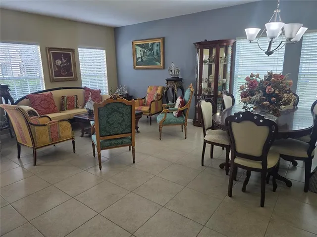 a living room with lots of furniture and a large window