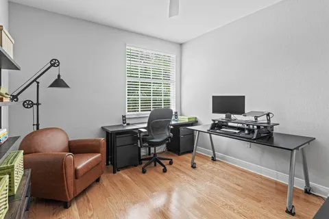 a livingroom with workspace and a window