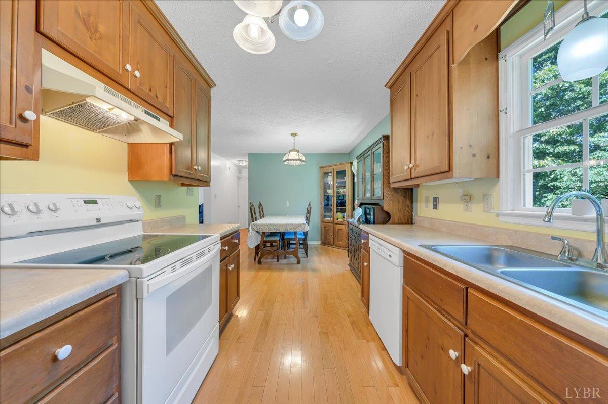 1124 Homeplace Road Bedford, VA 24523 - Photo 16 of 47 a kitchen filled counter top space a sink cabinets and a window