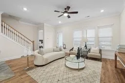 a living room with furniture and a chandelier