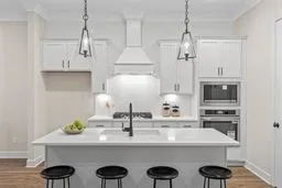 a kitchen with cabinets a sink and appliances