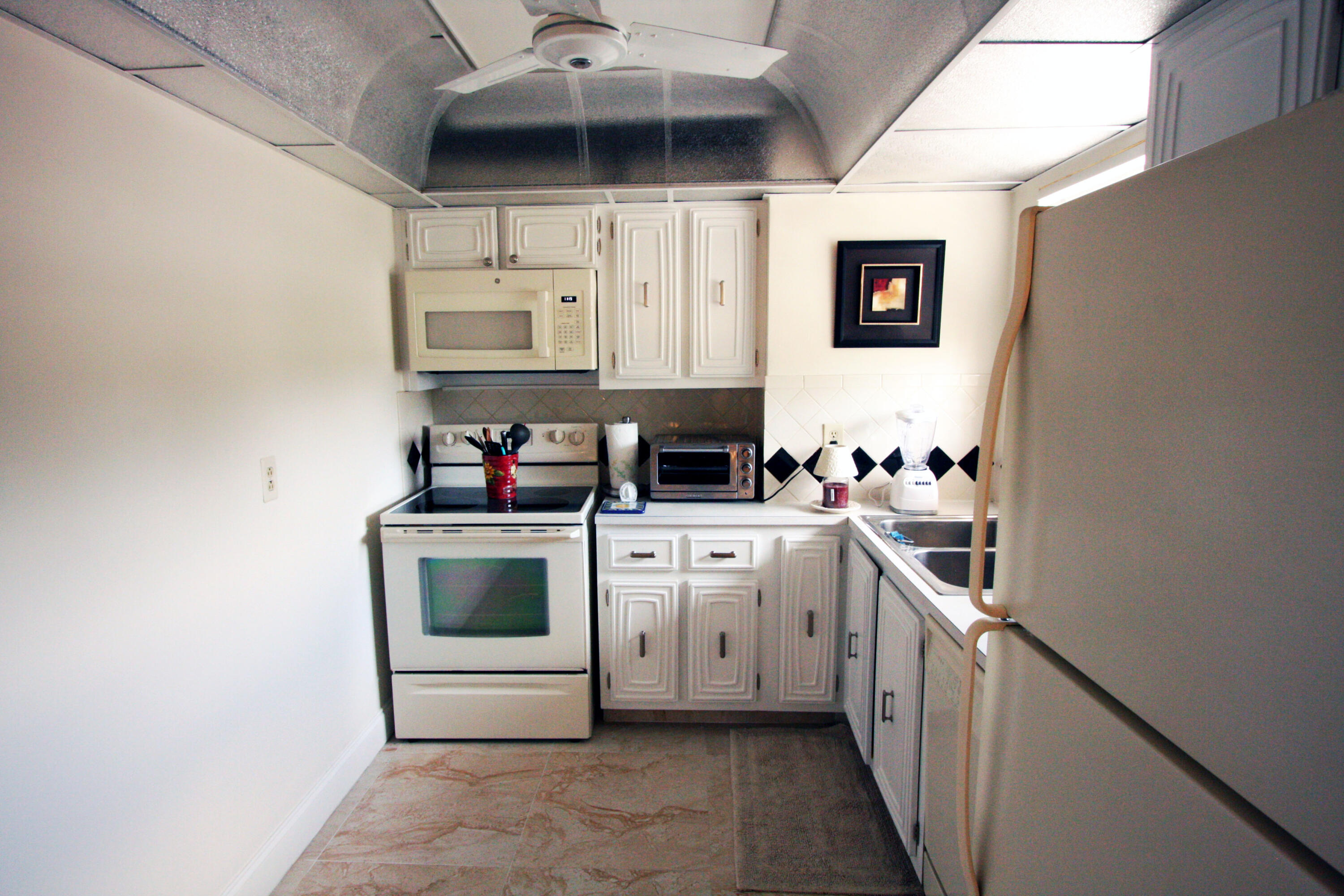 a kitchen with stainless steel appliances a stove microwave and cabinets