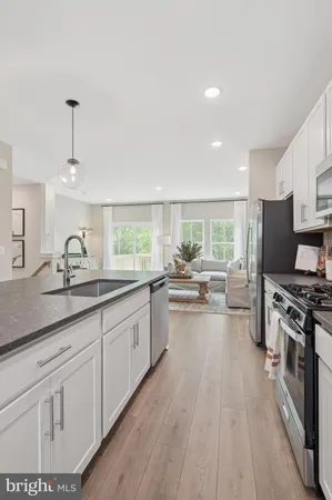 a kitchen with sink stove and refrigerator
