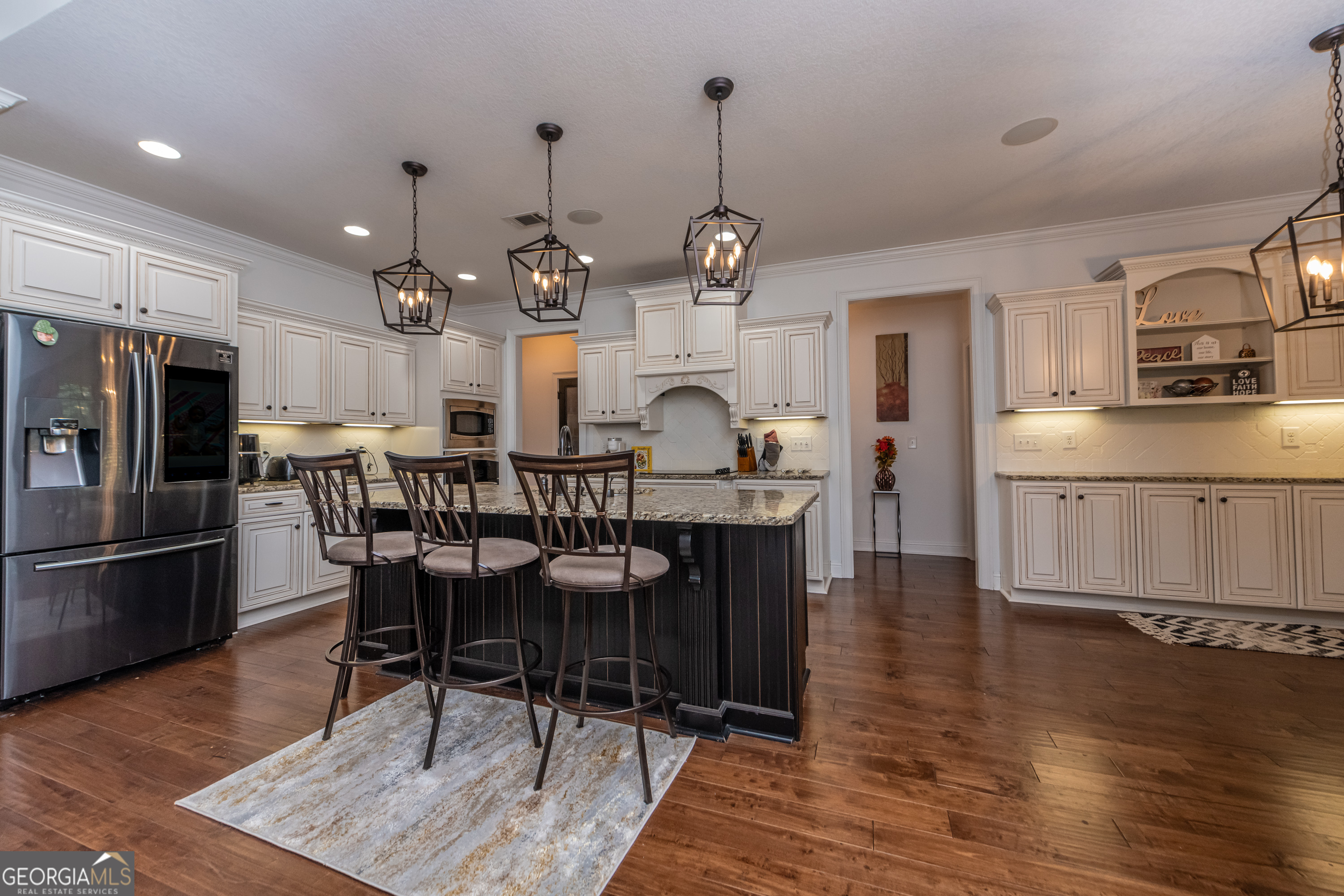 405 Old Bridge Road Warner Robins, GA 31088 - Photo 13 of 55 a view of a dining room and livingroom with furniture wooden floor a rug a fireplace and a chandelier
