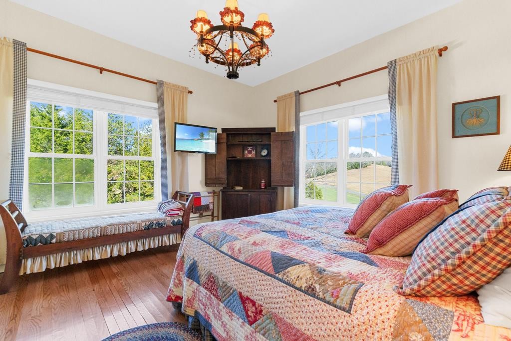 933 Millican Grove Road Sevierville, TN 37876 - Photo 24 of 54 a bedroom with a bed and a large window