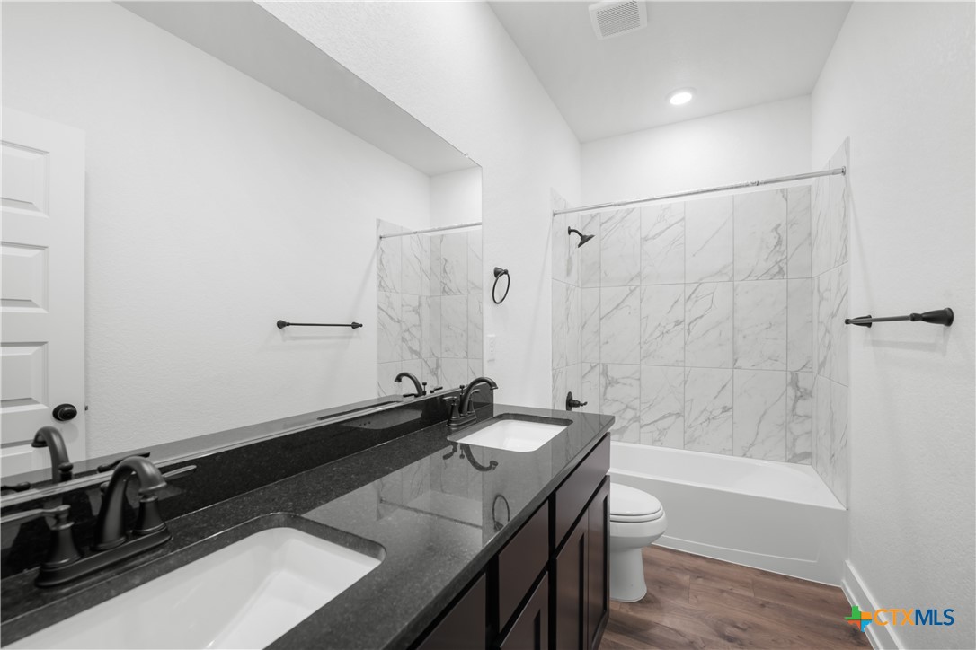 1803 Bear Grass Rdg Road Temple, TX 76501 - Photo 12 of 16 a bathroom with a sink and a mirror