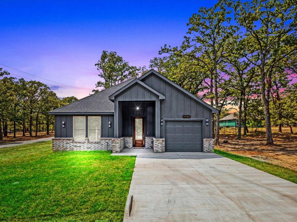 4705 Point La Vista Road Malakoff, TX 75148 - Photo 2 of 40 Contemporary exterior with vertical panel siding and a brick-and-stone facade