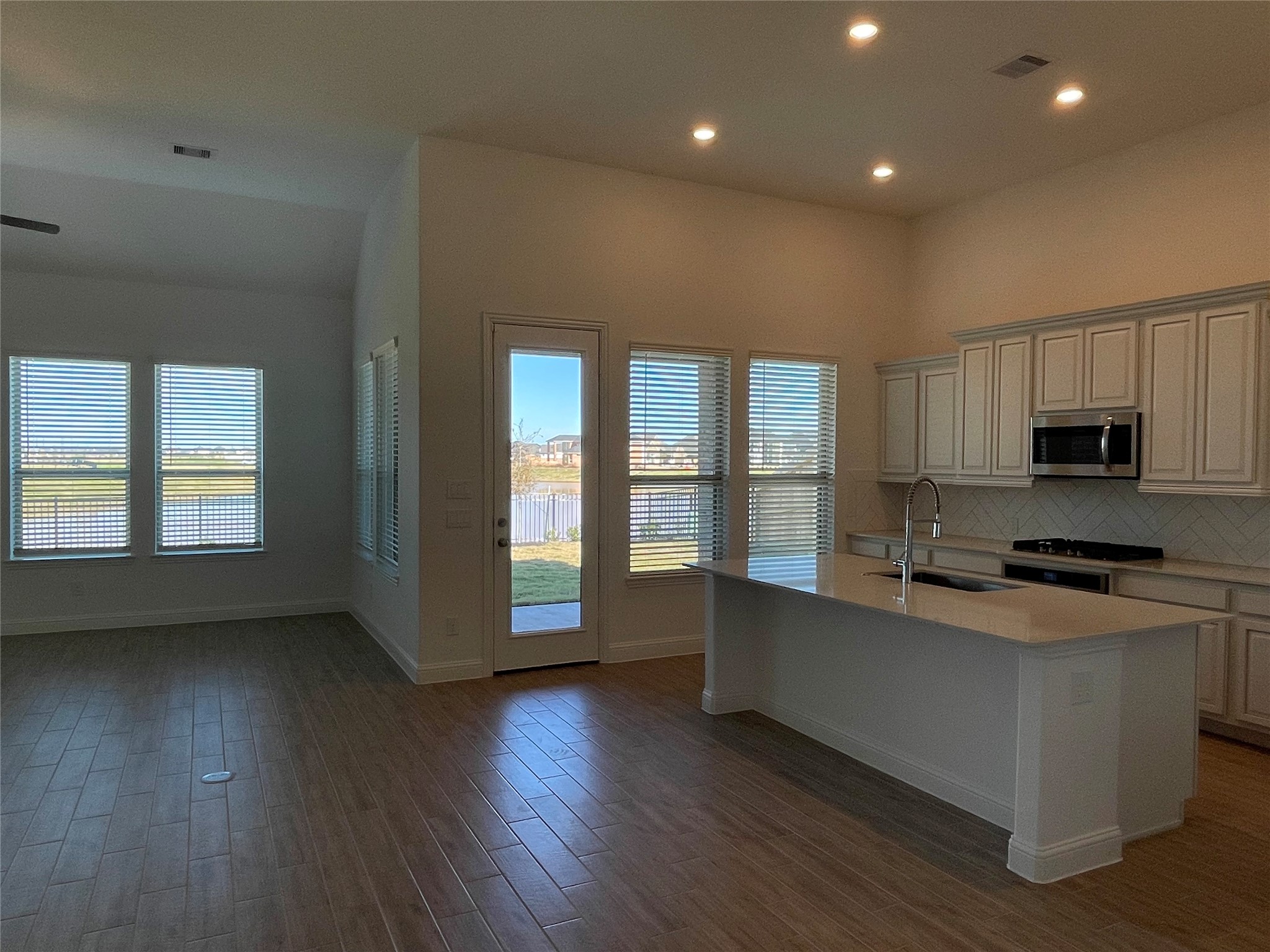 29806 Cherry Vine Road Katy, TX 77494 - Photo 10 of 30 a large kitchen with stainless steel appliances granite countertop a stove a sink a refrigerator and white cabinets with wooden floor