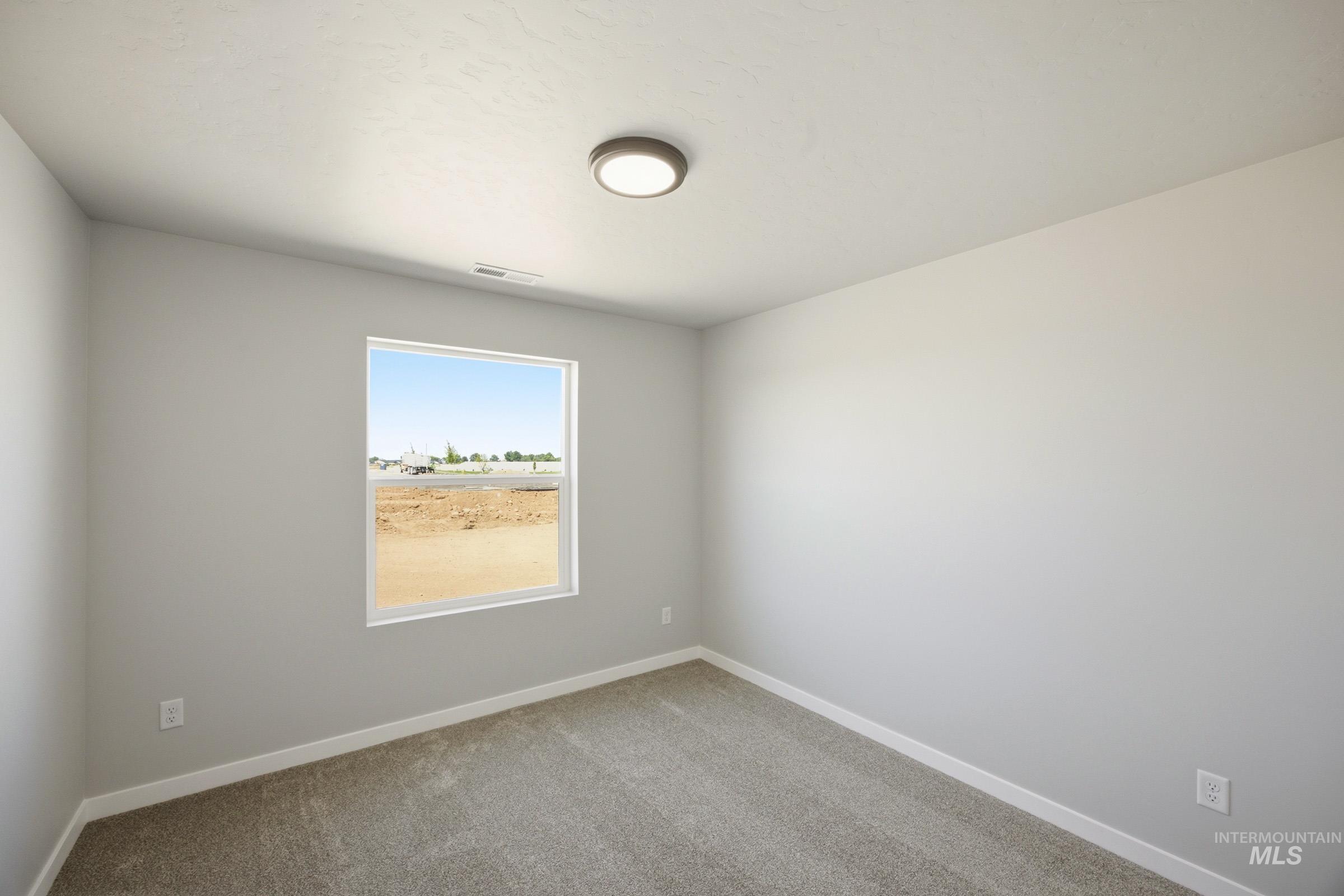 4344 East Rincon Drive Meridian, ID 83642 - Photo 12 of 26 Bright secondary bedroom with generous natural light from large window, neutral wall finishes, and soft carpet flooring