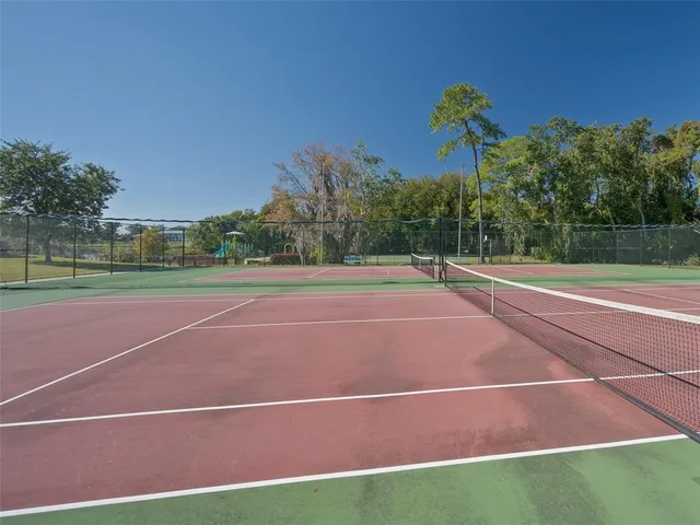 a view of a garden with houses in the background