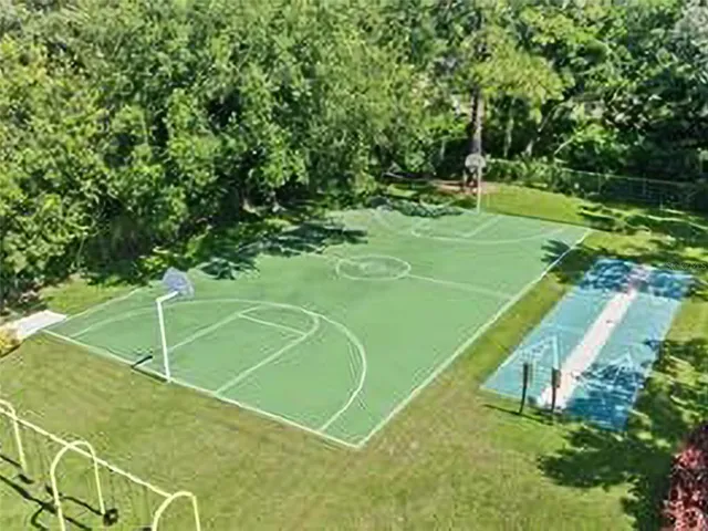 an aerial view of a pool with a yard