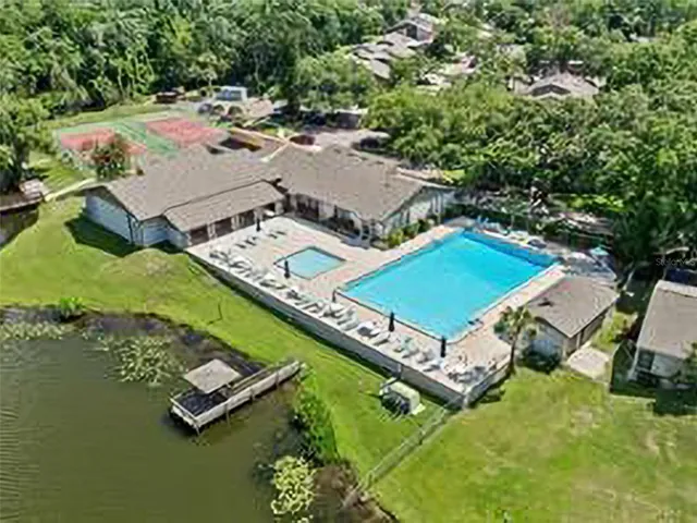 a view of a chair and table in backyard of the house