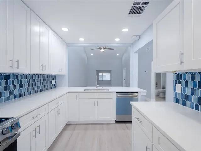 a kitchen with a refrigerator and cabinets