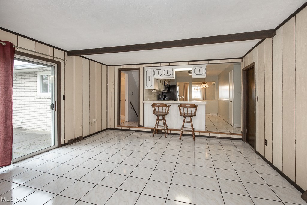 4569 McFarland Road Cleveland, OH 44121 - Photo 3 of 29 Unfurnished living room with beam ceiling