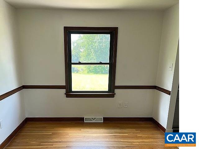 2807 Moyer Road Powhatan, VA 23139 - Photo 6 of 15 a view of an empty room with wooden floor and a window