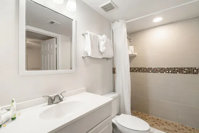 a bathroom with a sink vanity and mirror