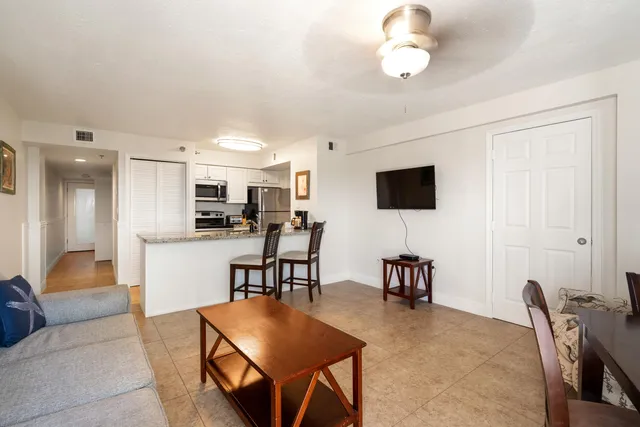 a bedroom with two beds and a chandelier