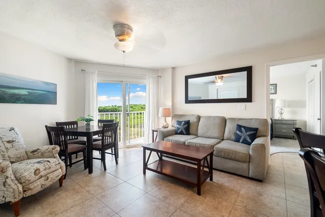a bedroom with a bed and a wooden floor