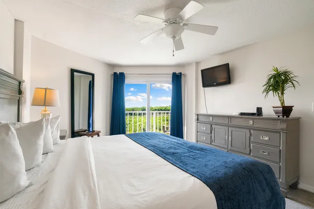 a kitchen with stainless steel appliances kitchen island granite countertop a refrigerator and cabinets