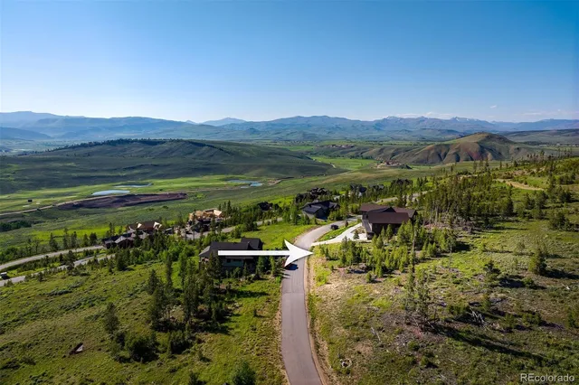a view of a town with mountains in the background