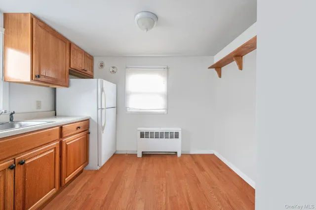 a kitchen with a refrigerator and cabinets