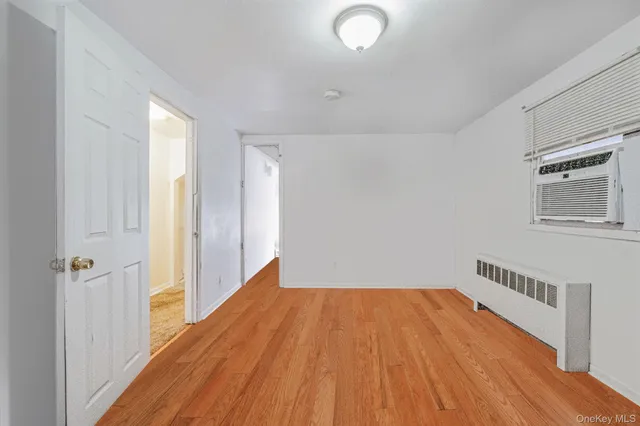 a view of a room with wooden floor and white walls