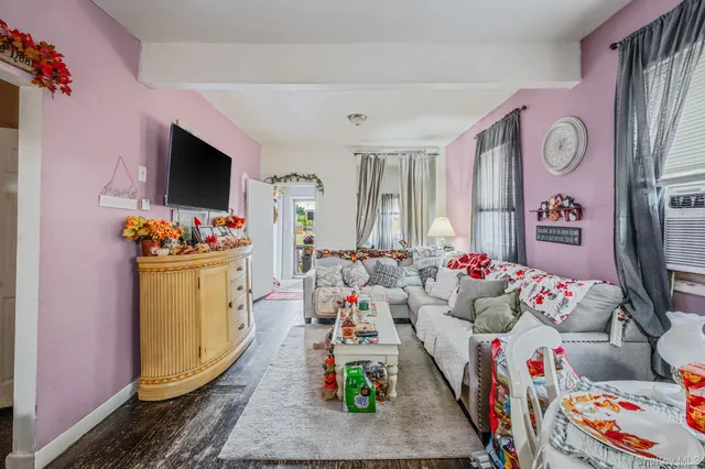 a living room filled with furniture and a flat screen tv